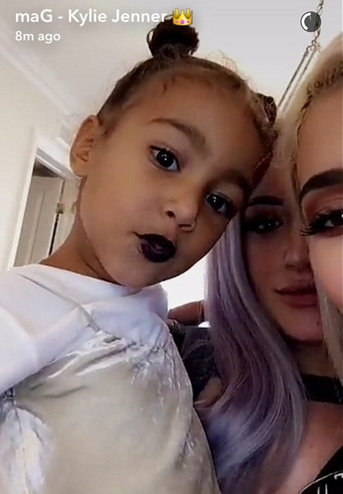 Kylie Jenner allows her little niece to put a lipstick on